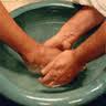 servant's hands washing feet